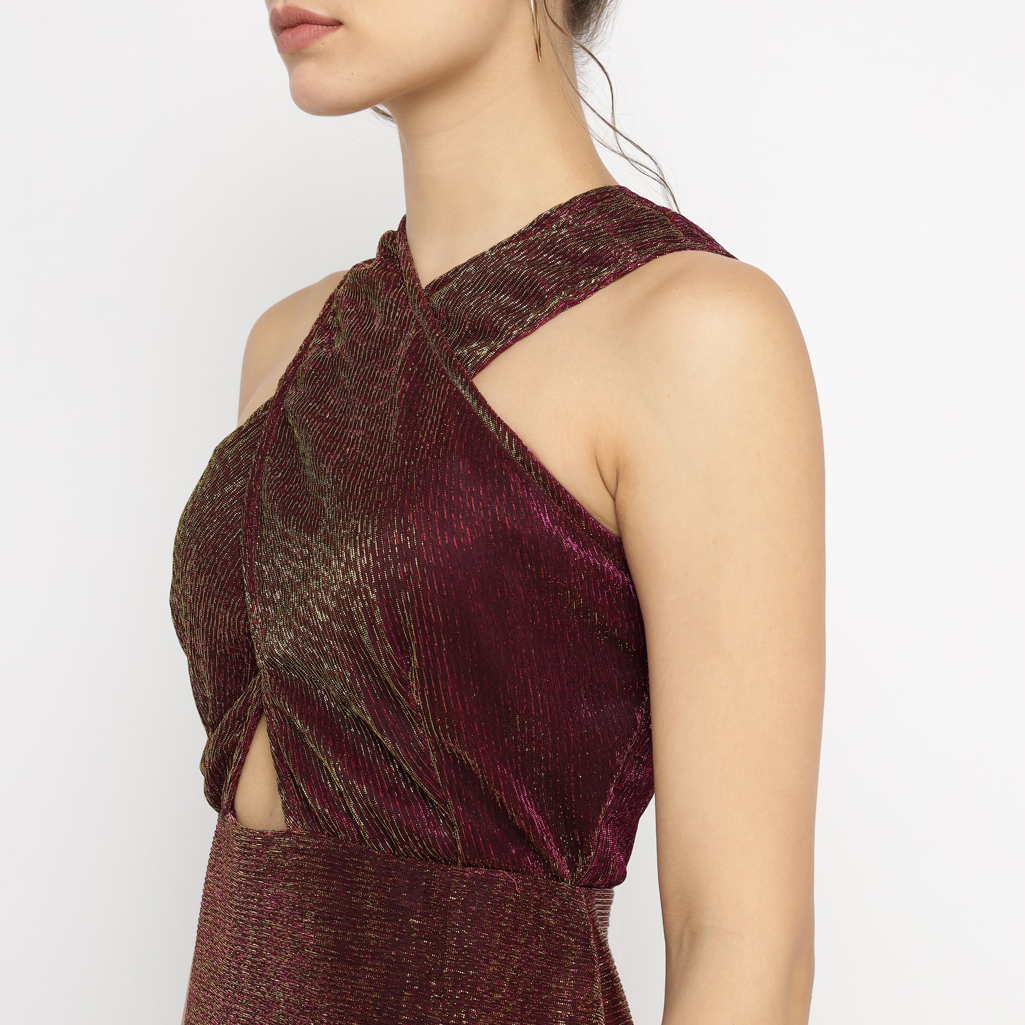 Close-up of burgundy-gold metallic bodycon mini dress featuring cross-front halter neckline and shimmering textured fabric – The Ulluu