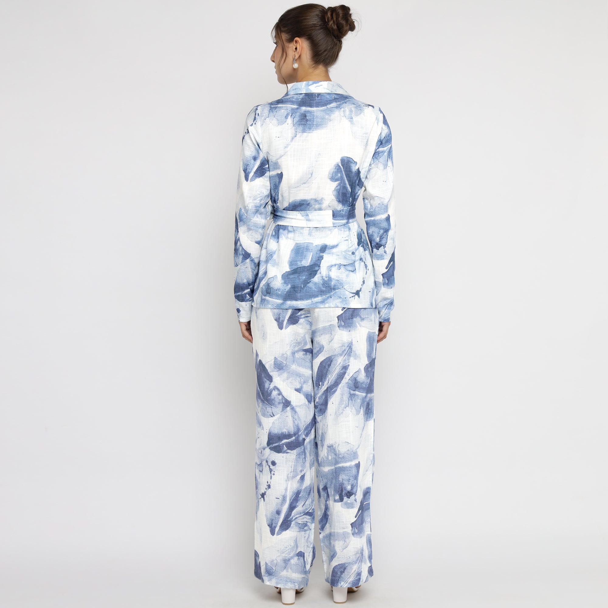 Back view of model wearing Blue & White Watercolor Printed Co-ord Set with long sleeves and wide-leg pants.