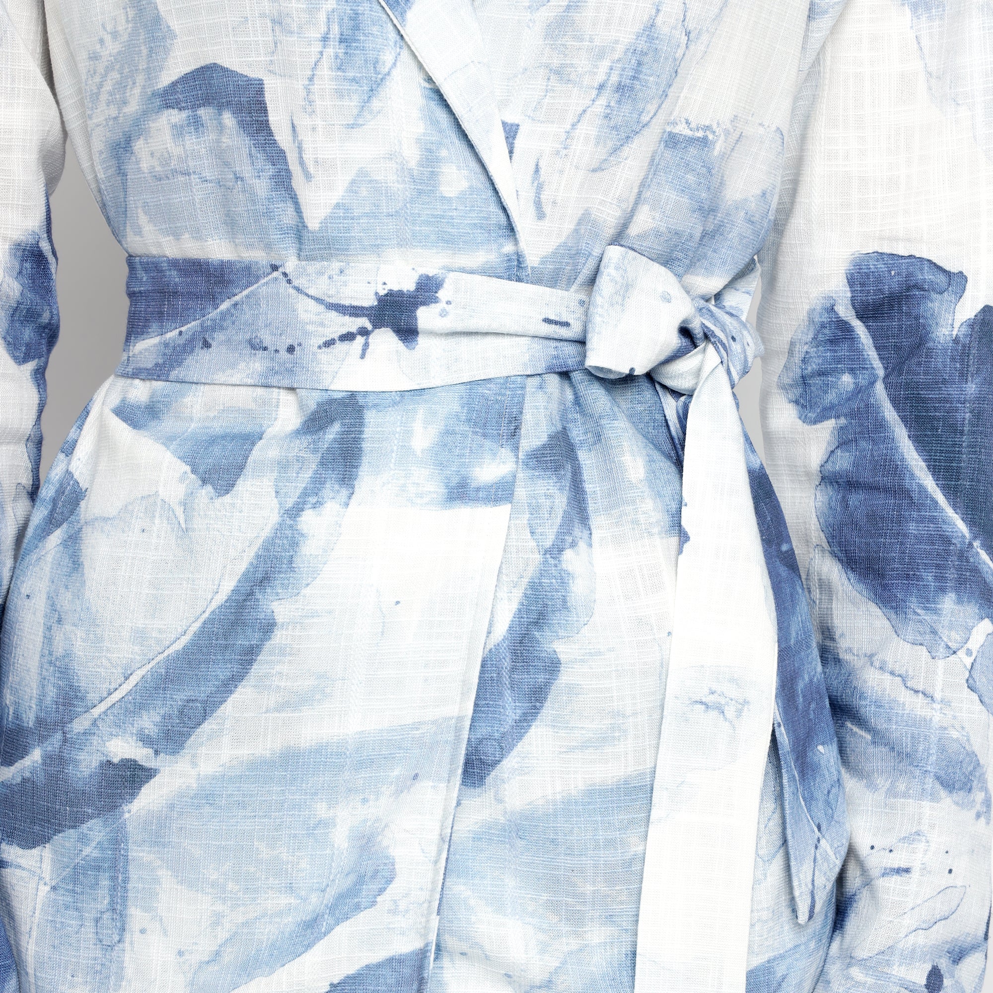 Close-up view of Blue & White Watercolor Printed Belted Blazer showing fabric texture and waist tie detail.