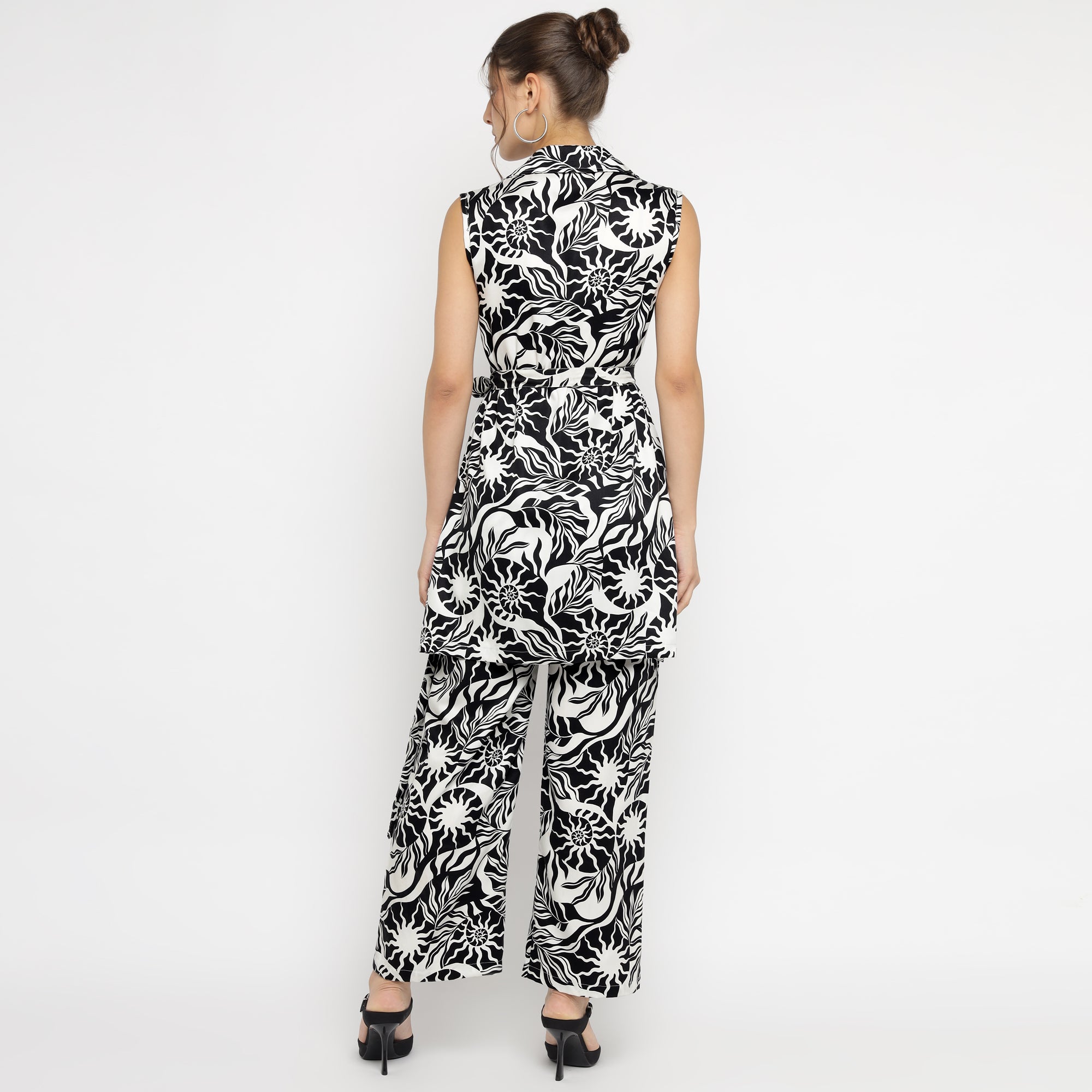 Back view of woman wearing black and white abstract printed sleeveless co-ord set with wide-leg pants – modern and chic design by The Ulluu