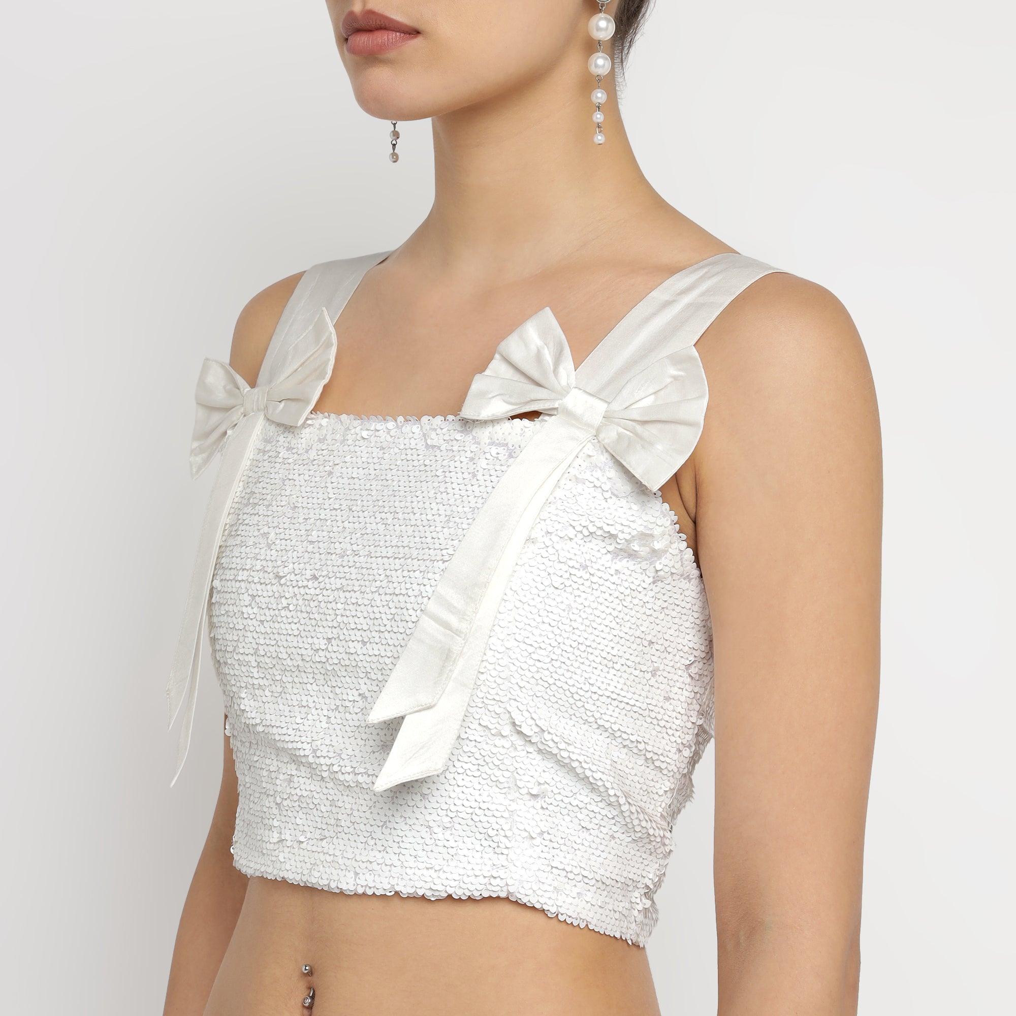 Close-up view of White Embellished Sequin Co-ord Set featuring bow-tie strap crop top, showcasing textured fabric and elegant detailing.